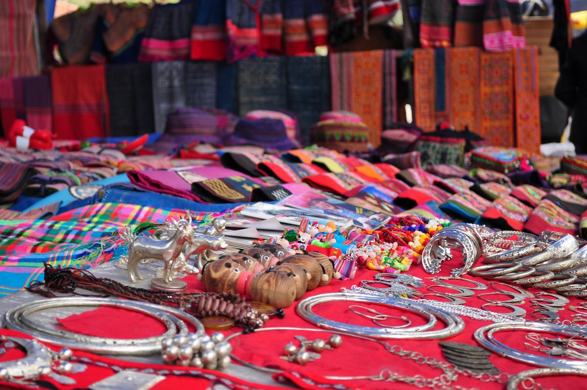 Vibrant scenes from Bac Ha Sunday Market, where a photographer captures colorful ethnic costumes.