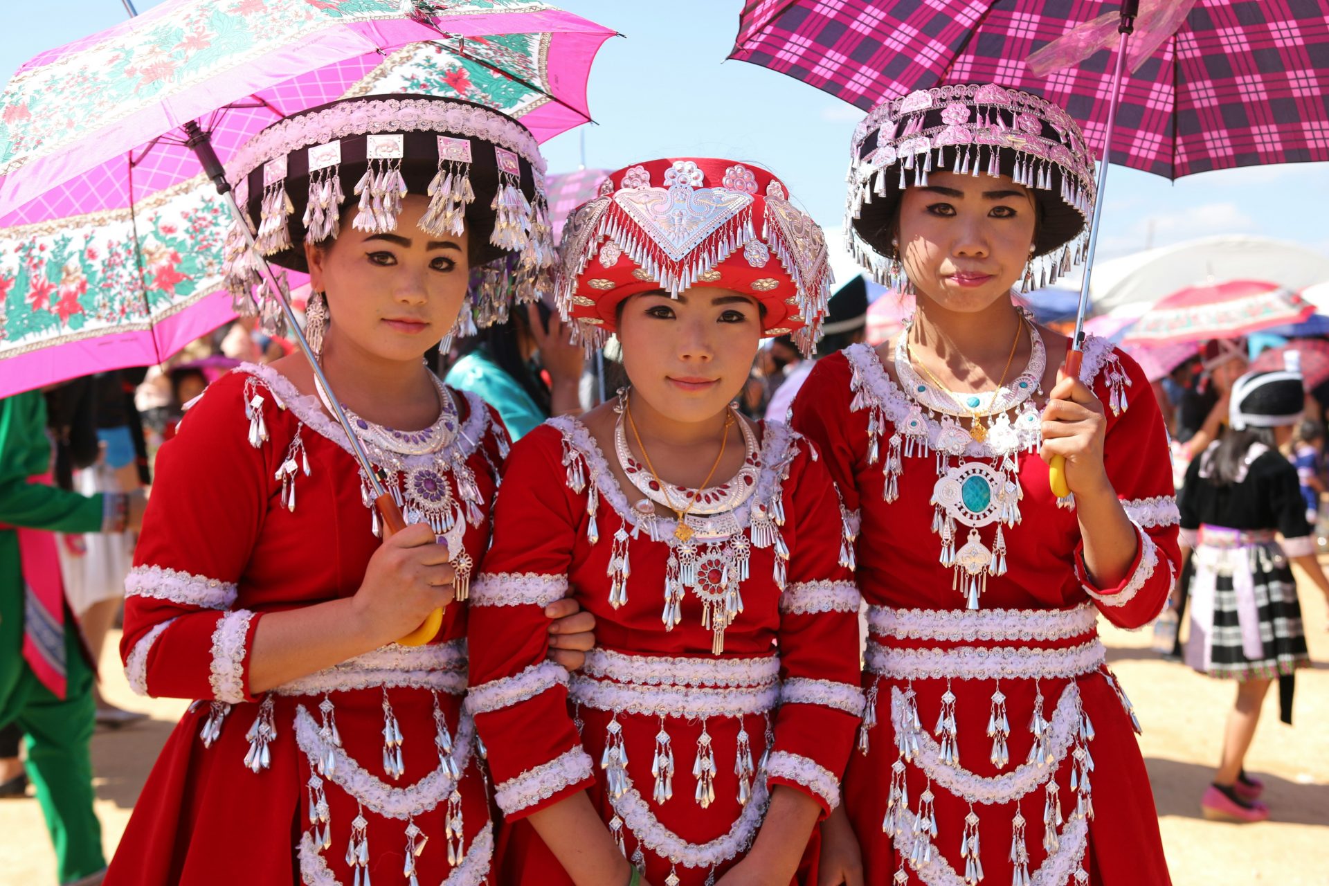 Close-up portrait of an Hmong woman in traditional dress taken respectfully by a travel photographer exploring cultural stories in northern Vietnam.