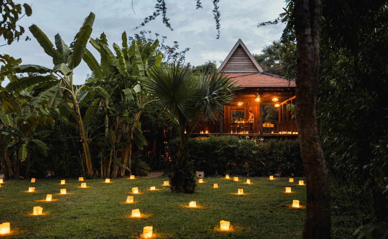 Cambodian village-themed luxury resort during sunset near Siem Reap.