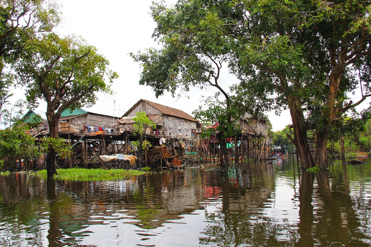 Exploring Tonle Sap Lake floating village with traditional wooden houses on the water in Cambodia.