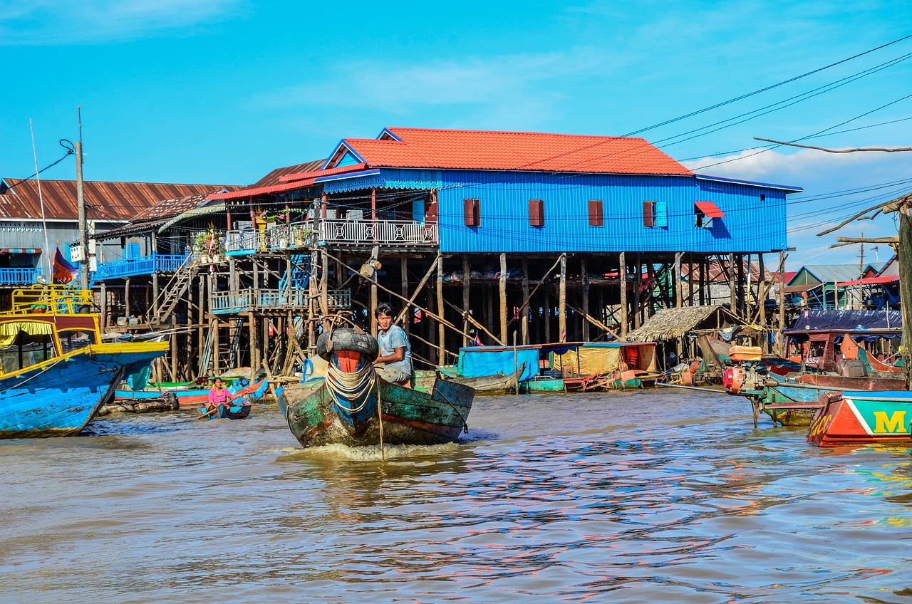 Colorful stilt houses and boats in Kompong Phluk village on Tonle Sap Lake, Cambodia.