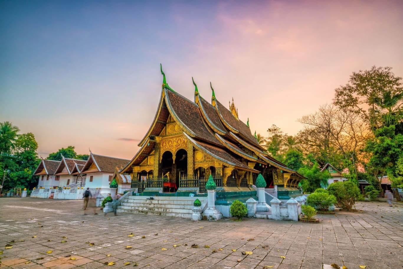 Wat Xieng Thong temple lit at night in Luang Prabang — a must-see site for spiritual travel in Laos.