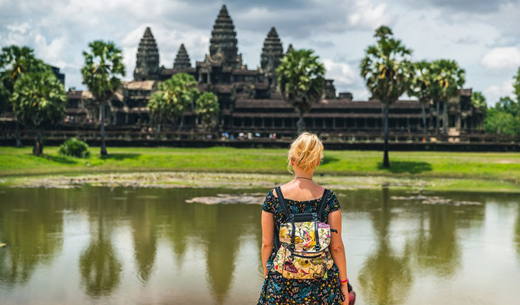 Cambodia culture tours at temples - Visitors in modest dress paying respects at Angkor Wat