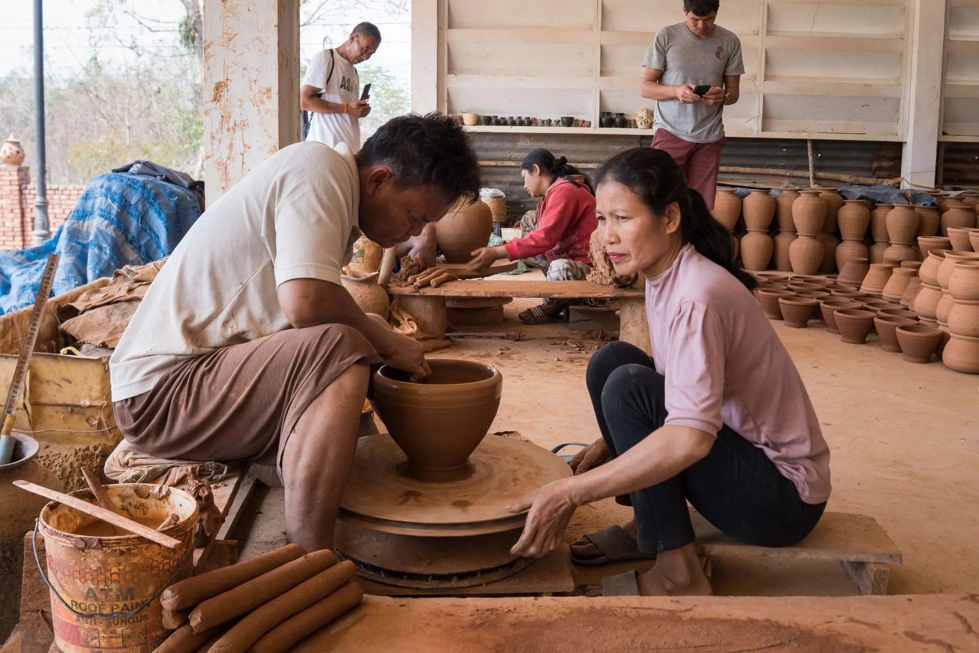 Laos DMC tour to Ban Chan - Local artisans hand-shaping clay pots