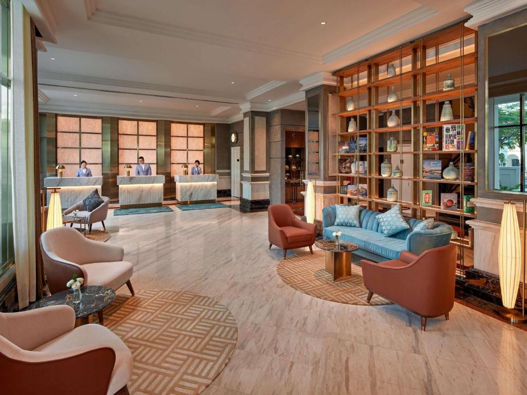 Stylish hotel lobby with reception and seating area at mövenpick hotel hanoi