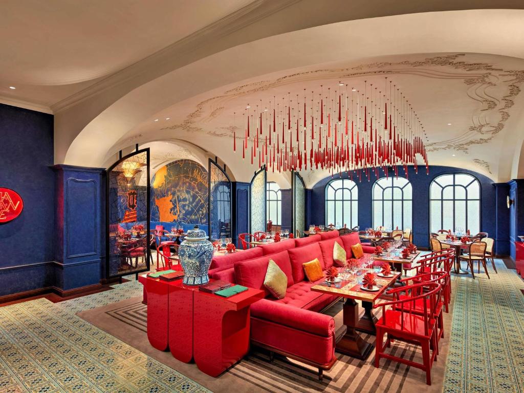 Elegant fine dining restaurant with red interior design at mövenpick hotel hanoi