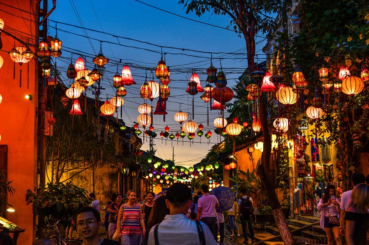 Vietnam night market tradition - Releasing wish lanterns along Hội An's historic lantern-lit alleyways