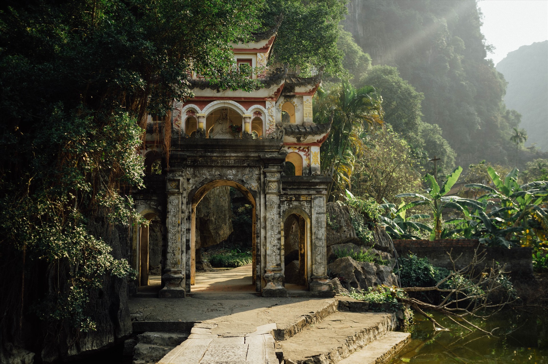 Bich Dong Pagoda nestled in limestone cliffs of Vietnam Ninh Binh, surrounded by lush greenery