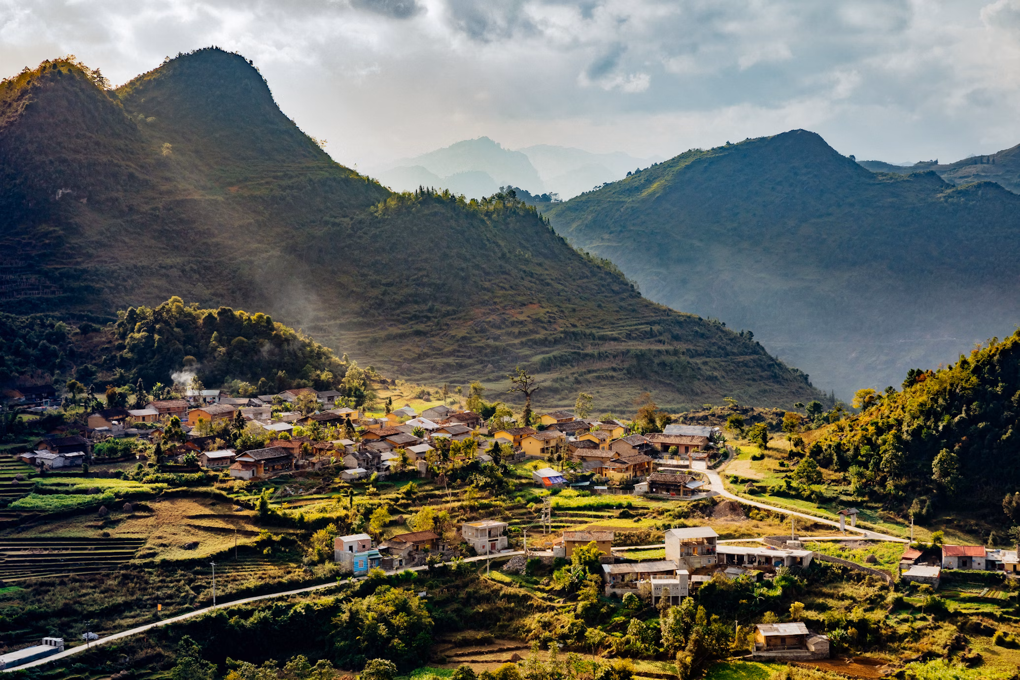 Mountain village nestled in the valleys of Ha Giang, northern Vietnam—showcasing traditional life and the raw beauty of an authentic Vietnam experience.