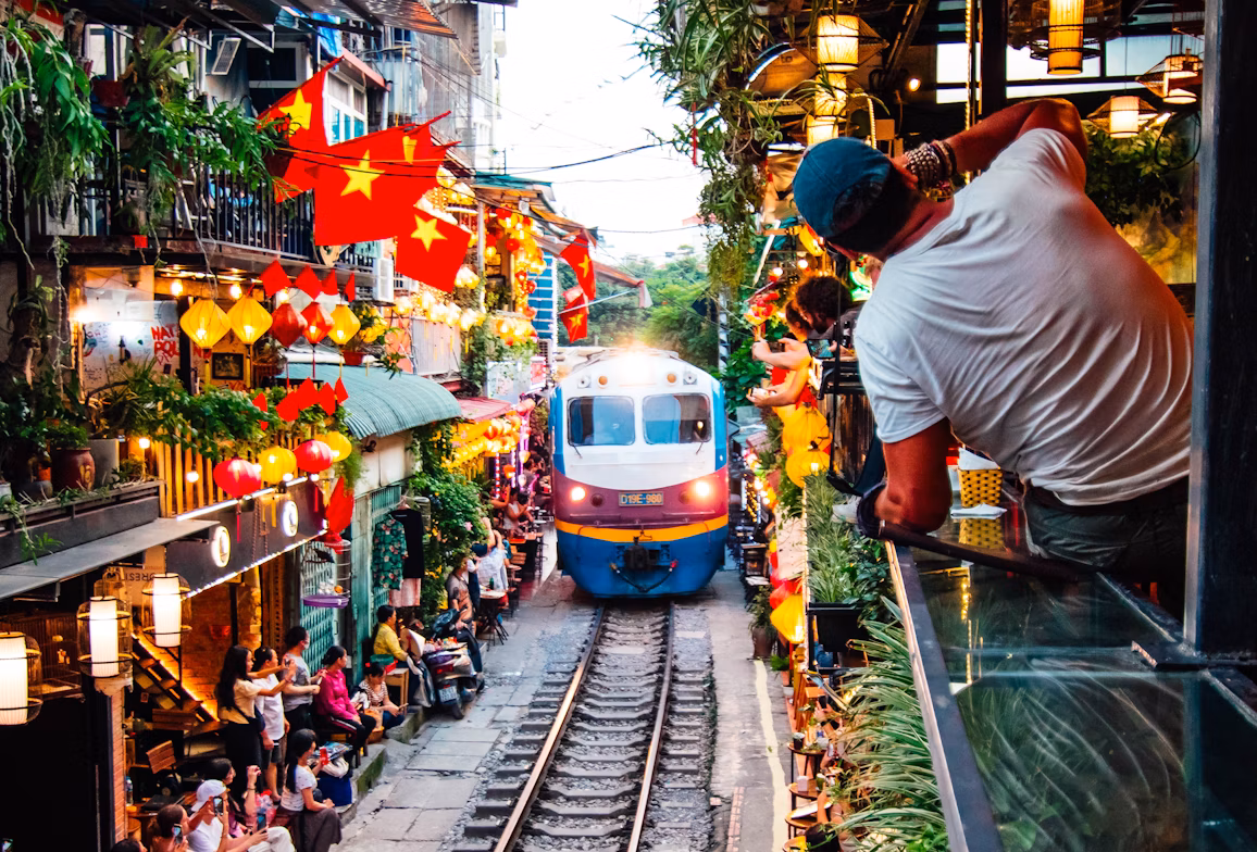 Train passing through Hanoi's iconic street café scene