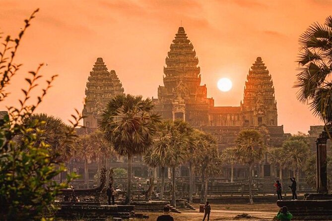 Travel to Angkor Wat to witness the spectacular sunrise silhouetting the ancient temple's iconic towers