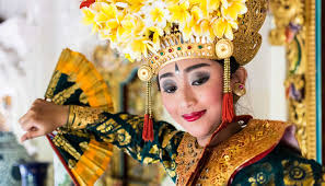A small, vibrant canang sari offering on the ground, demonstrating respect for a daily Balinese ritual in Southeast Asia culture.