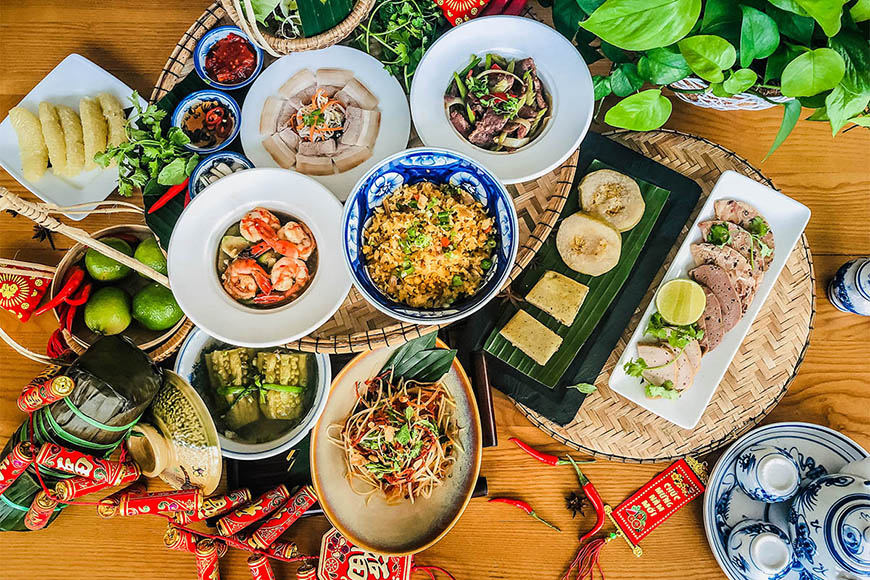 Central Vietnamese New Year’s Food feast with pork, shrimp, sticky rice, and Bánh Tét, showcasing regional Tết culinary traditions.