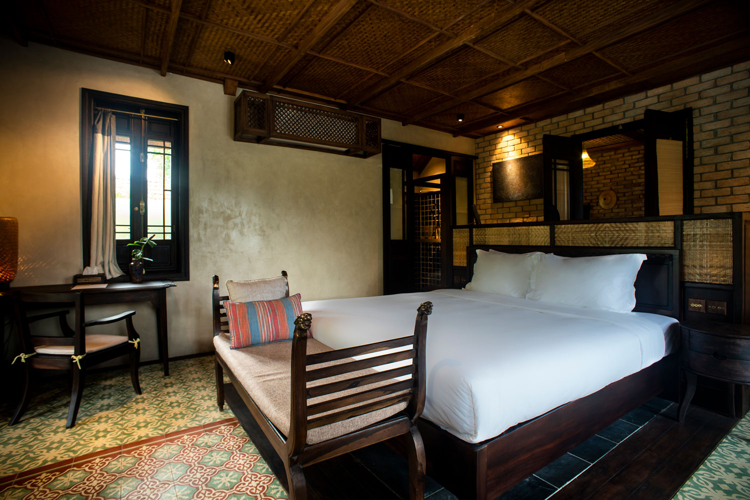 Mountain Veranda Chamber at Tam Coc Garden Resort with rustic design, wooden furniture, tiled floor, and cozy atmosphere.