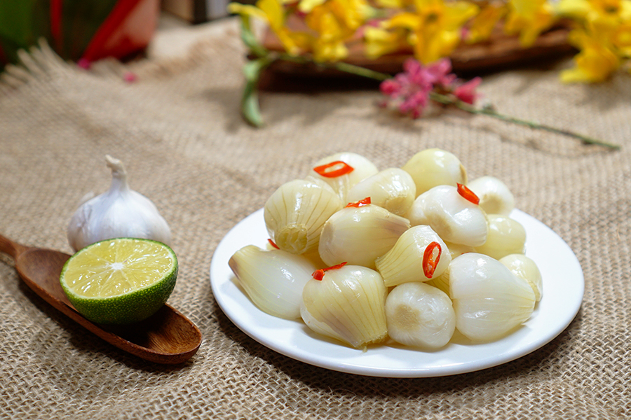 Pickled onions with chili and garlic, a refreshing Vietnamese New Year’s Food side dish balancing flavors in traditional Tết meals.