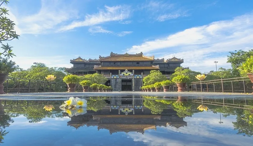 The Imperial City of Hue is reflected in water on a bright day, perfect for visiting Vietnam in May
