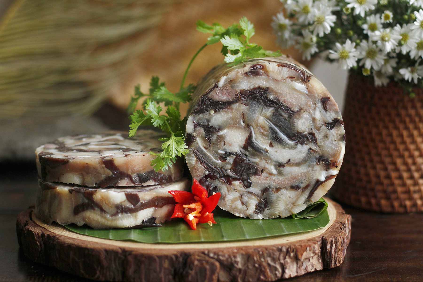 Giò thủ, a savory Vietnamese New Year’s Food made from pork, mushrooms, and spices, symbolizing abundance during Tết celebration.
