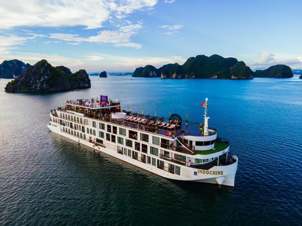 An aerial view of the luxurious Indochine Premium Cruise ship sailing on the calm waters of Ha Long Bay, Vietnam in August