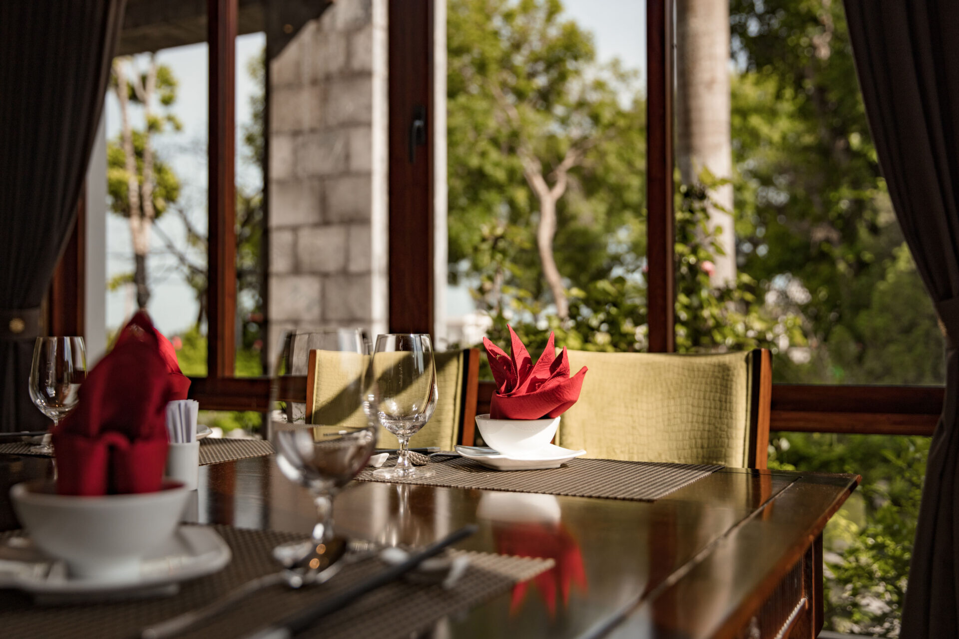 Cozy dining table at Ninh Binh Hidden Charm Hotel & Resort with natural light and scenic garden view.