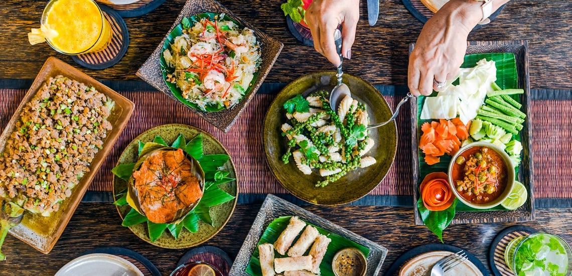 A colorful and vibrant market stall in Siem Reap, Cambodia, showcases fresh, local ingredients for Cambodian cuisine