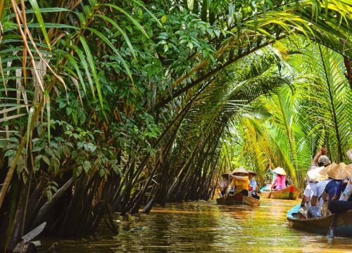 Narrow, lush green waterway in the Mekong Delta