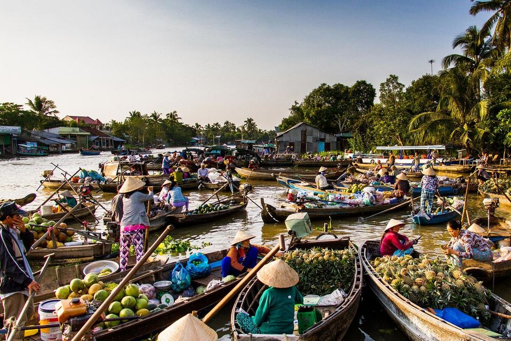 Floating market in Mekong Delta, Vietnam in March – vibrant local life on boats filled with fruits and goods.
