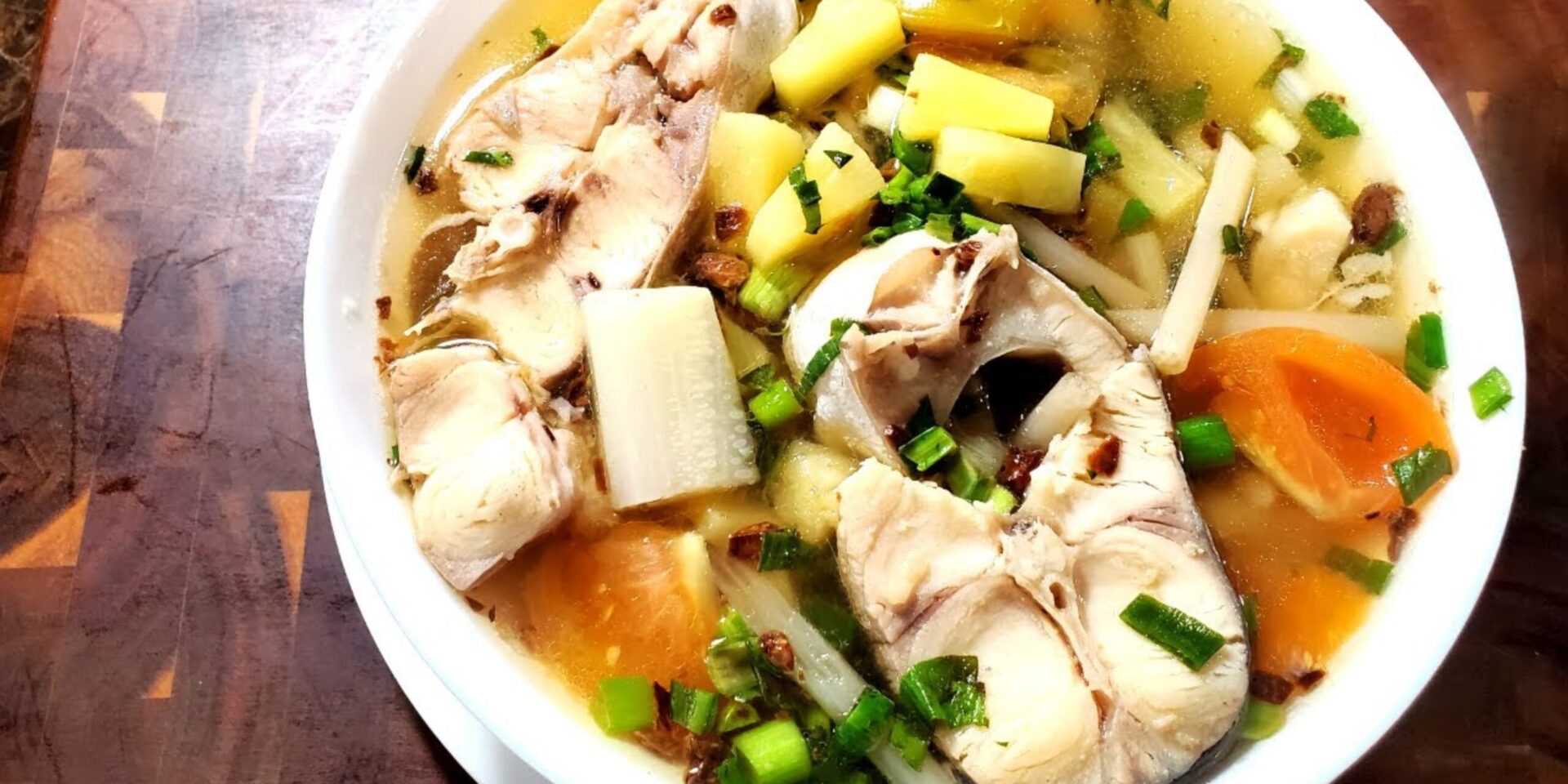 A bowl of samlor machu trey, a sweet and sour fish soup in Cambodian cuisine.