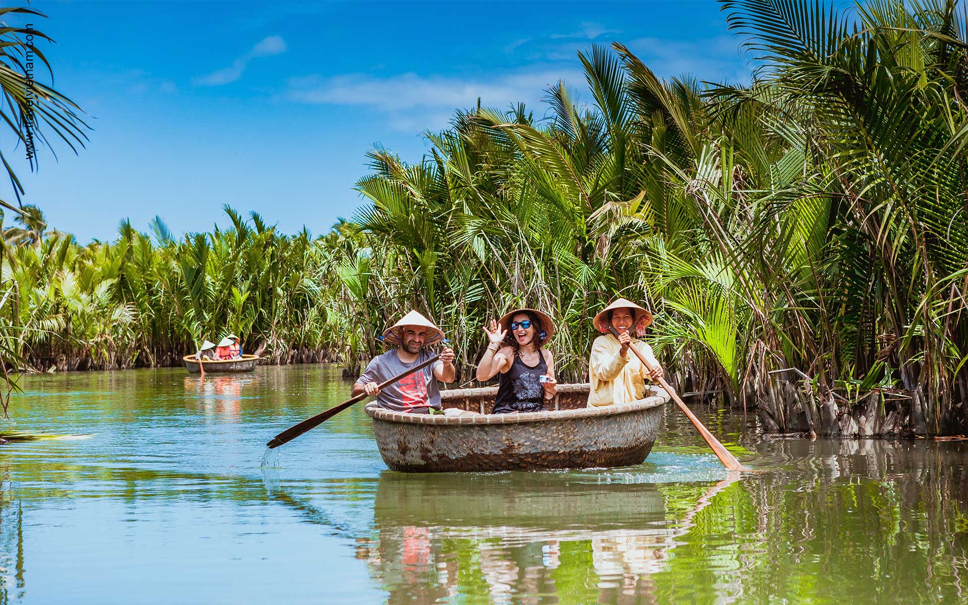 Paddling a traditional basket boat (thúng) through a dense coconut palm forest in the Mekong Delta, an accessible activity when travelling Vietnam solo