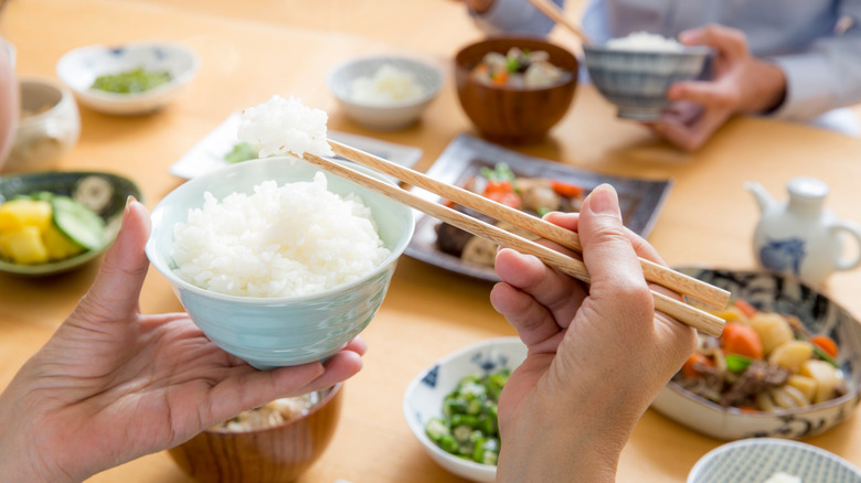 Avoiding chopsticks upright in a bowl of rice, a important funeral-related taboo in Southeast Asia culture