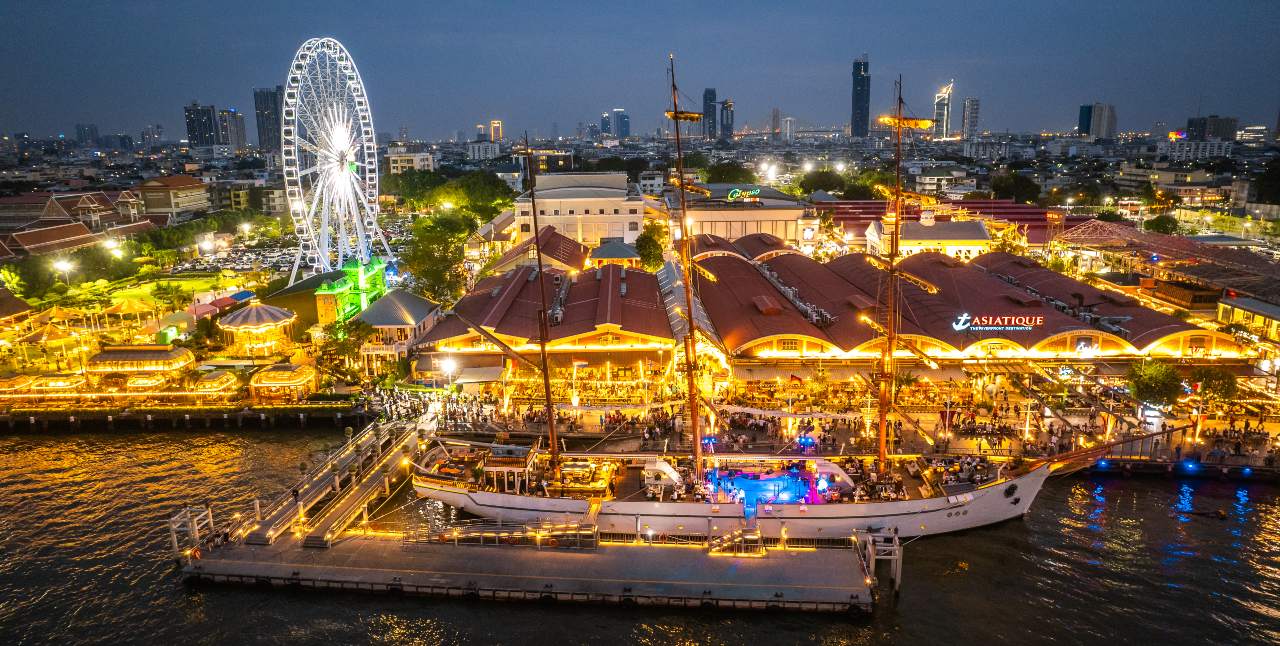 Aerial night view of Asiatique The Riverfront, a large Bangkok night market and entertainment complex