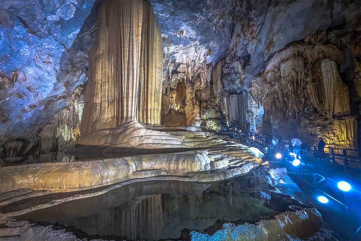 The massive, illuminated formations and stalactites inside Paradise Cave, showing a spectacular Vietnam adventure site