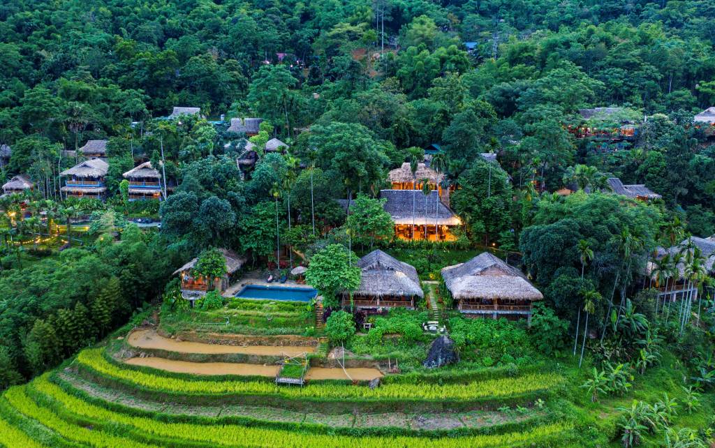 Aerial view of the luxury eco-lodges and terraced rice fields at Pu Luong Retreat
