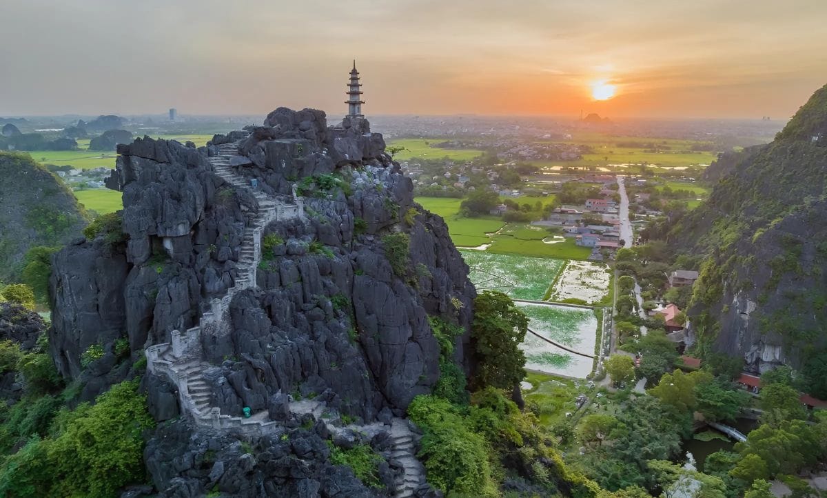 Aerial view of Mua Caves in Ninh Binh, with sunset over the rice fields, a highlight during the best time to visit ninh binh