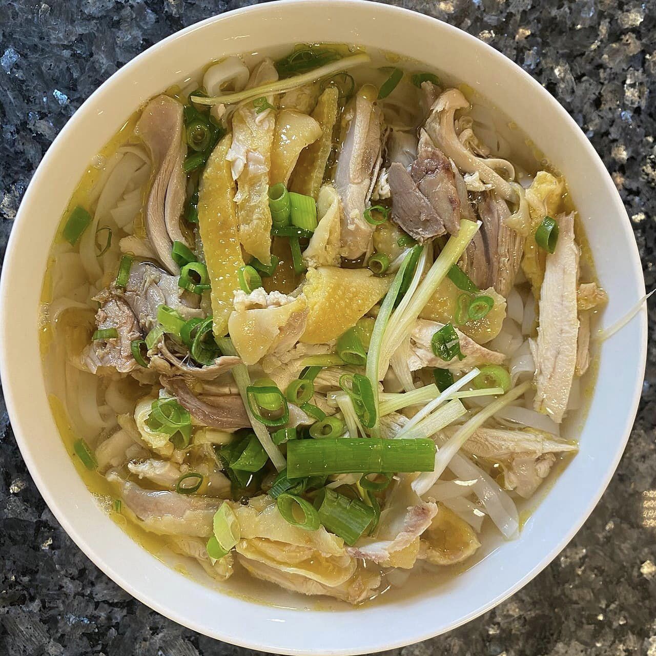 Close-up of a bowl of traditional Vietnamese chicken noodle soup (Phở Gà), a popular street food in 36 Streets Hanoi