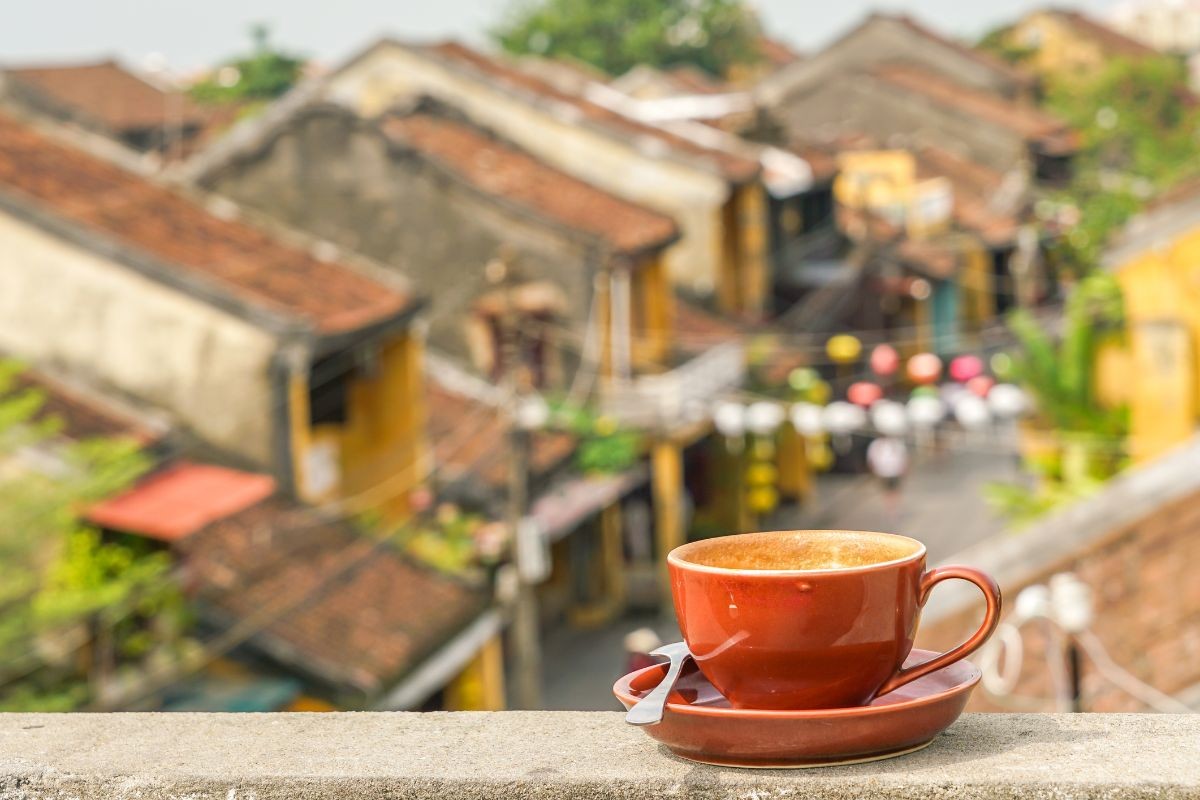 A cup of strong Vietnamese coffee on a rooftops of Hoi An's old town, a relaxing moment during a hoi an private tour