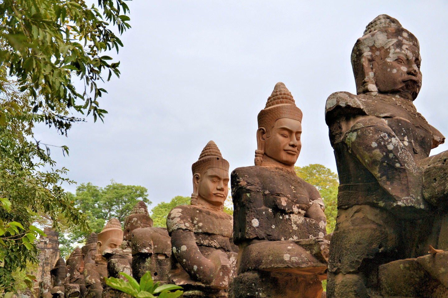 Angkor Wat tours passing Angkor Thom guardian statues