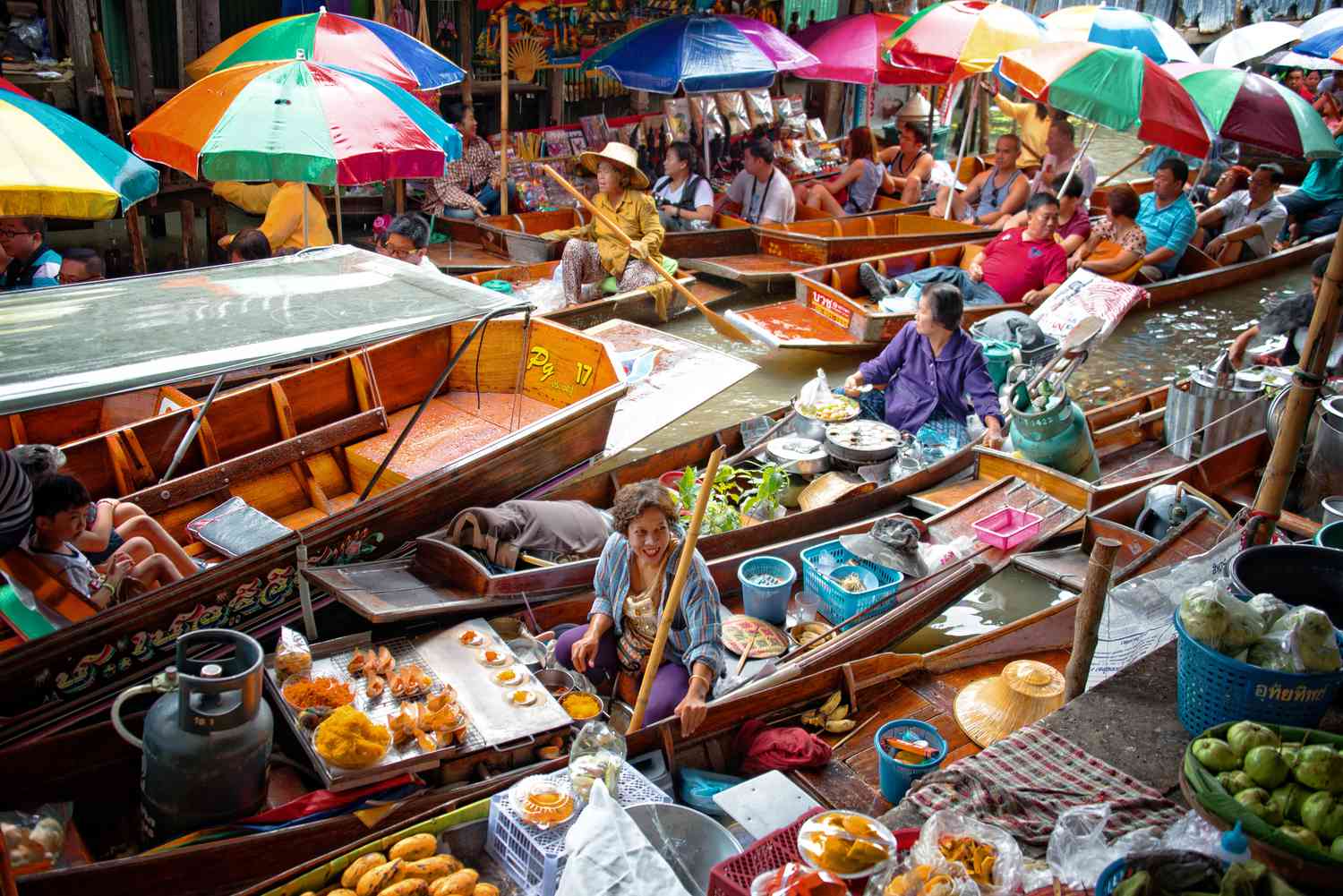 A bustling scene at a Bangkok floating market tour