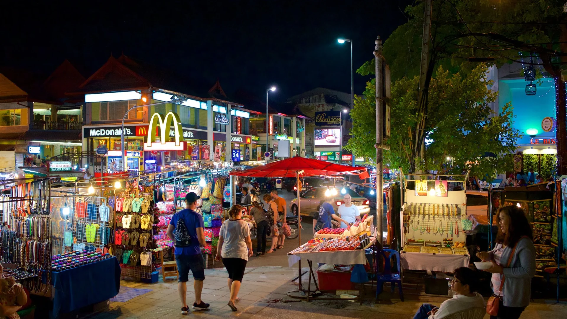 A bustling street scene at one of Chiang Mai's iconic Night Bazaars, highlighting the commercial vibrancy of chiang mai nightlife