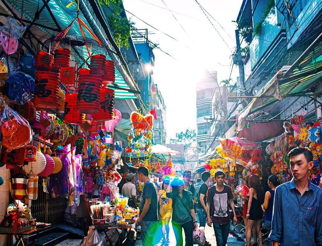 Vibrant lantern street in Chinatown highlights lively ho chi minh city sightseeing vibes.