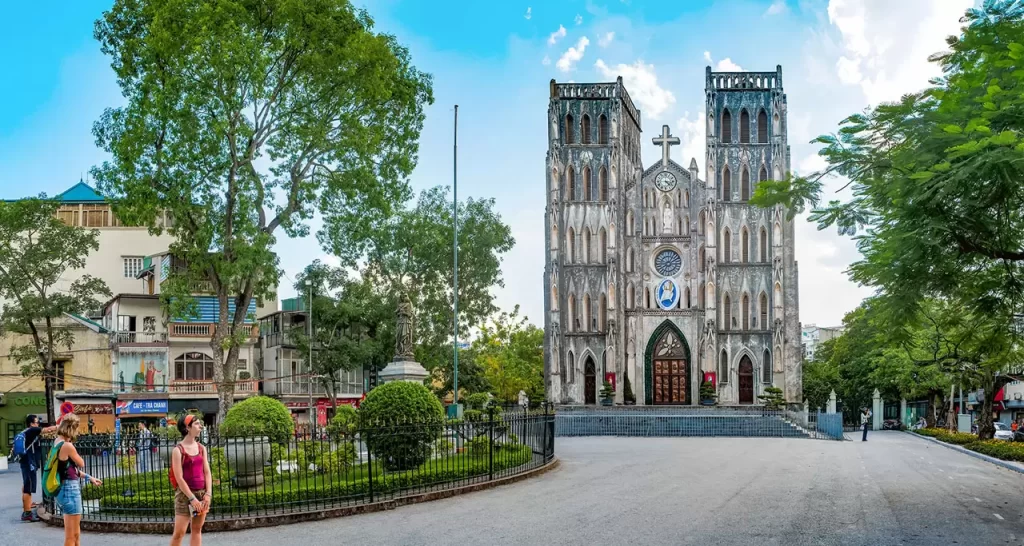 The imposing stone facade of St. Joseph's Cathedral in Hanoi, a popular landmark included in hanoi day tours