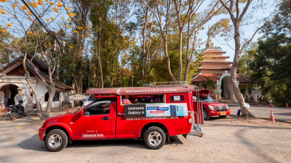 A distinctive red songthaew, a common mode of transport, ready for a city tour Chiang Mai