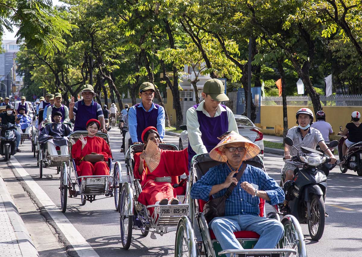 A line of cyclos carrying tourists in Hanoi, illustrating "hanoi day tours."