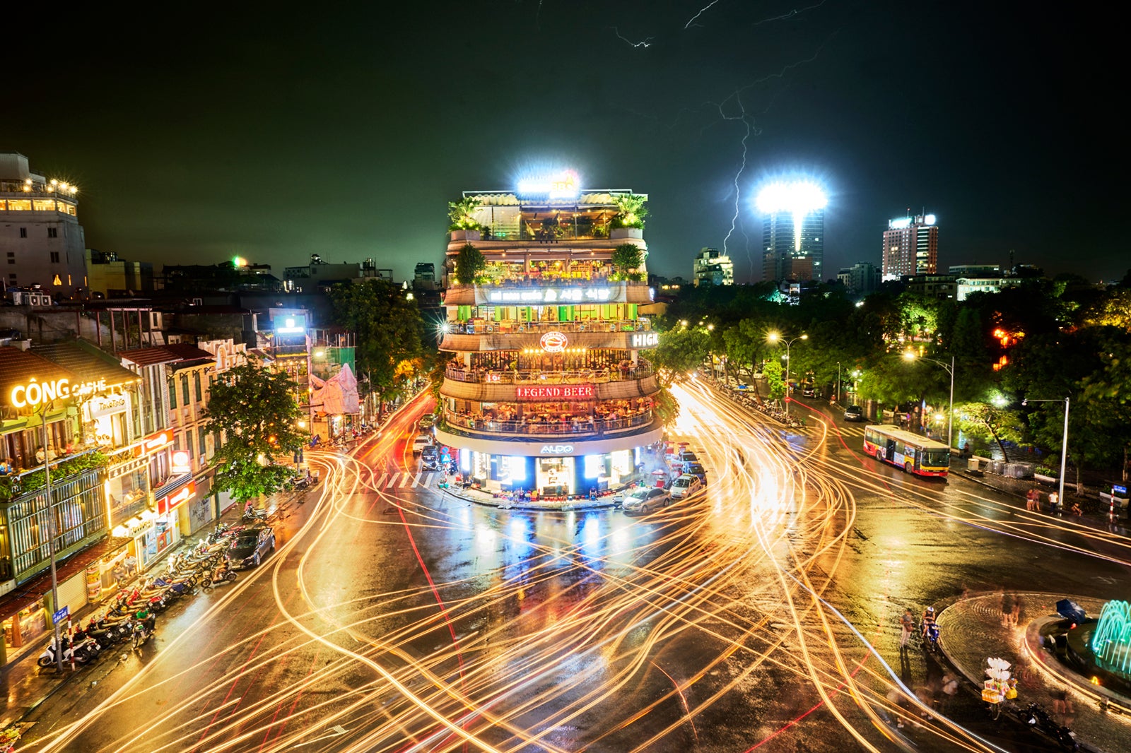 Tranquil by Day, Energetic by Night: Busy Hanoi Beer Street scene with crowds of tourists and locals enjoying street-side drinks, highlighting the energetic nightlife contrast.