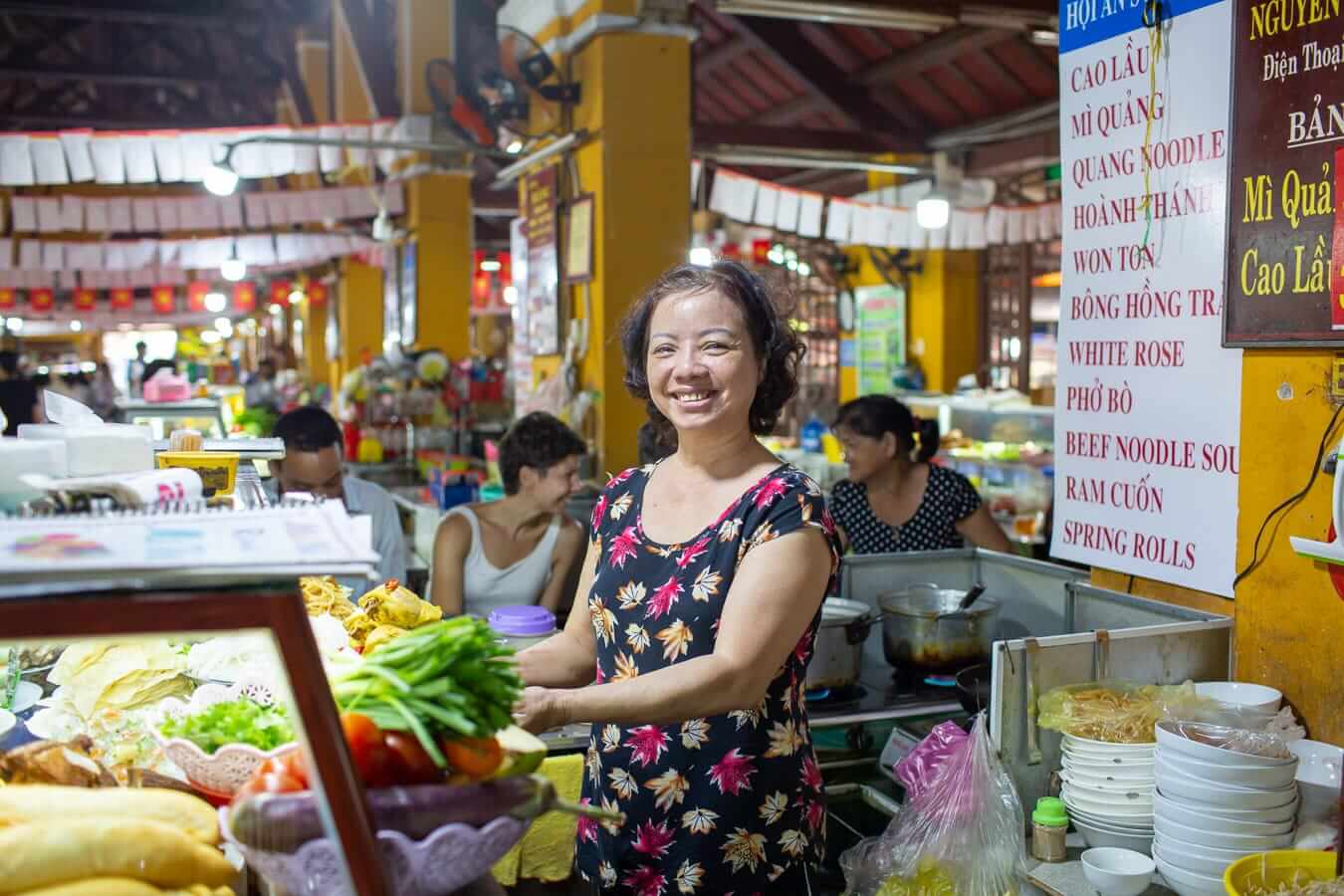 Food stall vendor at Hoi An Central Market. Great for sampling local cuisine on a Vietnam Itinerary.