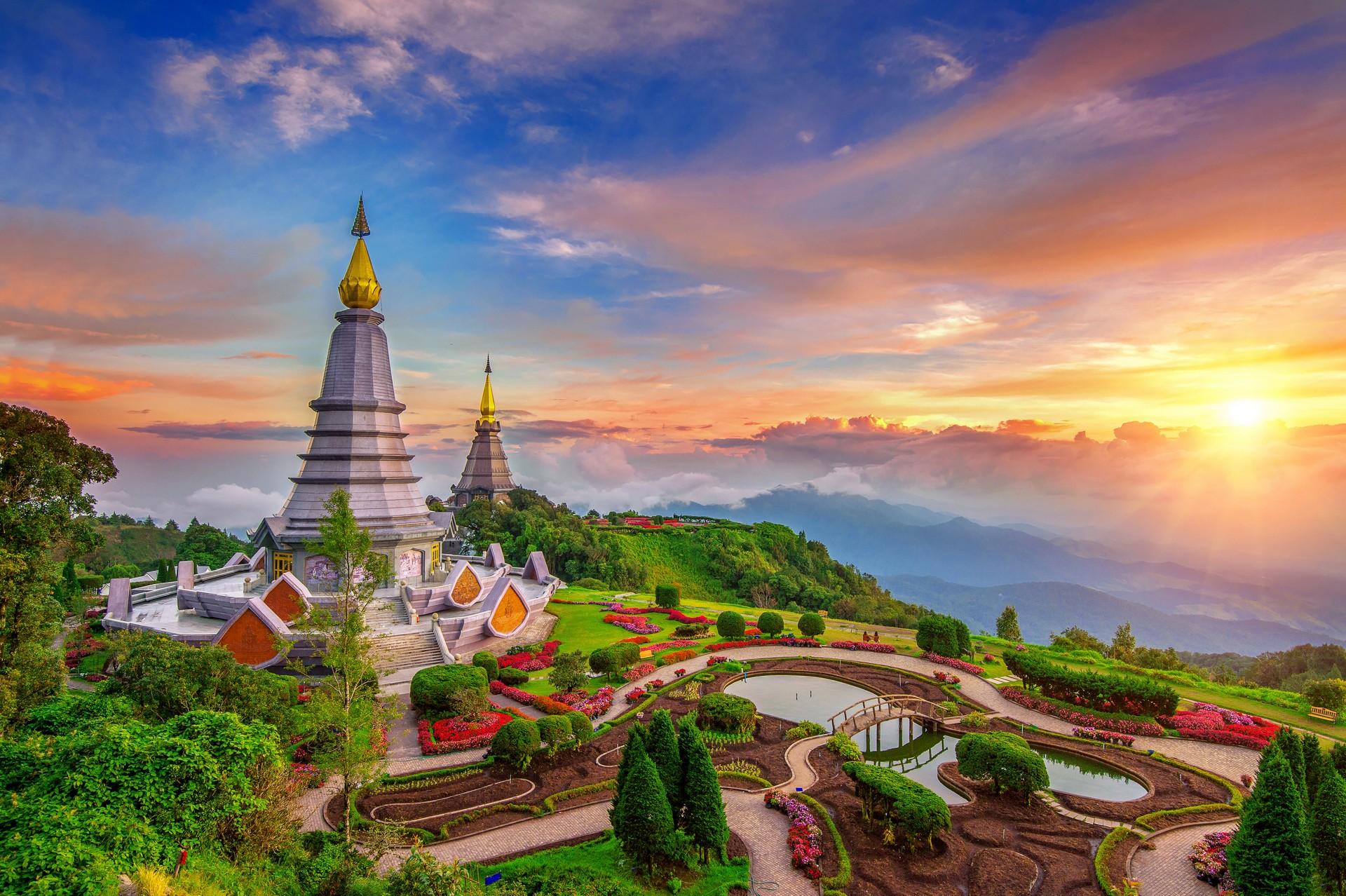 The Cool Season (November - February): The Ideal Period: A stunning sunset over Doi Inthanon's twin pagodas in Chiang Mai, highlighting the clear skies and comfortable weather of the perfect travel season.