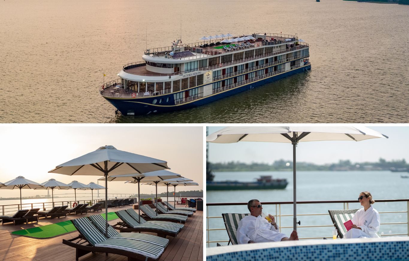 Experiencing Vietnam Cambodia Cruise: Luxury cruise ship on the Mekong River, showing spacious sun decks with loungers and passengers relaxing under umbrellas.