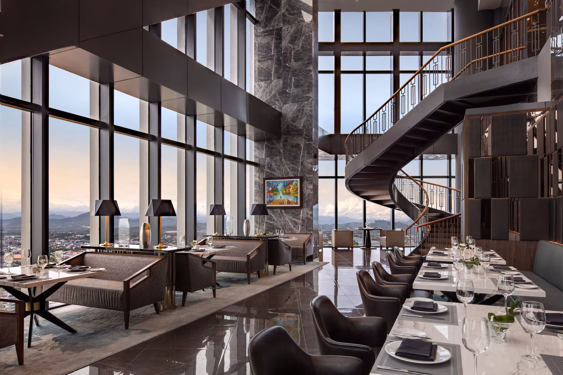 Sophisticated dining area at Melia Vinpearl Hue with floor-to-ceiling glass, marble interiors, and stunning panoramic city views.