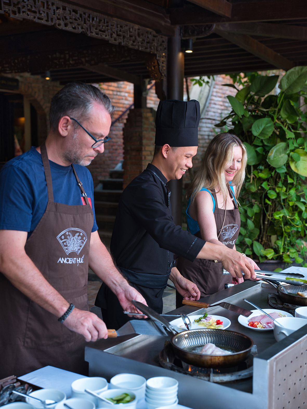 Cooking class at Ancient Hue Garden Houses where guests learn traditional Vietnamese recipes under the guidance of professional local chefs.