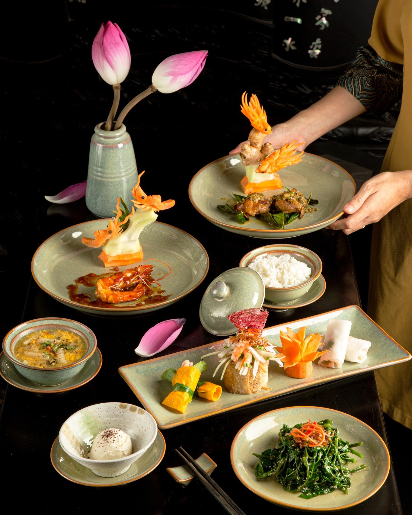 Exquisite royal meal at Ancient Hue Garden Houses showcasing artfully carved ingredients, lotus flowers, and authentic Vietnamese culinary presentation.