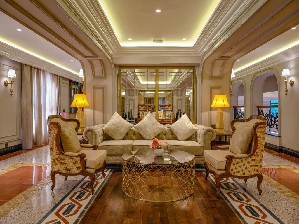 Elegant lounge area at silk path grand hue hotel with classic furniture and warm lighting.